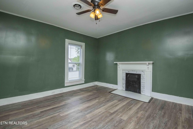 2918 Johnston St, Knoxville, TN 37921 - unfurnished living room featuring wood finished floors, a brick fireplace, ornamental molding, ceiling fan, and baseboards