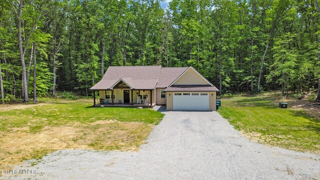 98 Paso Fino Trl, Jamestown, TN 38556 - view of front facade with a porch, driveway, a front yard, and an attached garage