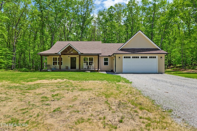 98 Paso Fino Trl, Jamestown, TN 38556 - single story home featuring a porch, a garage, gravel driveway, and a front lawn