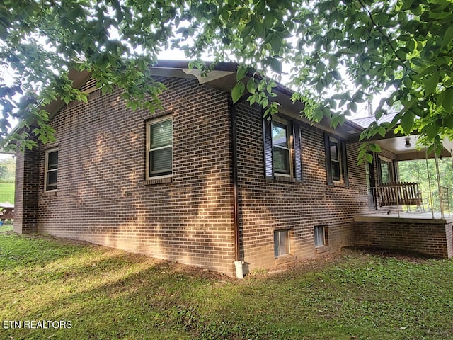 3381 Upper Caney Valley Rd, Tazewell, TN 37879 - view of property exterior featuring brick siding, a lawn, and a porch