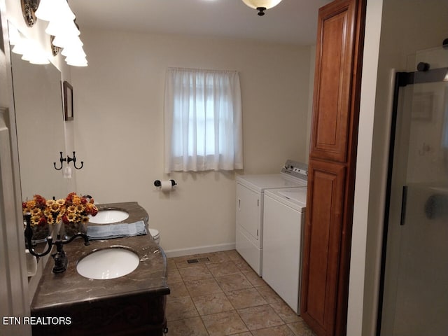 3381 Upper Caney Valley Rd, Tazewell, TN 37879 - bathroom with washing machine and dryer, baseboards, double vanity, and an enclosed shower