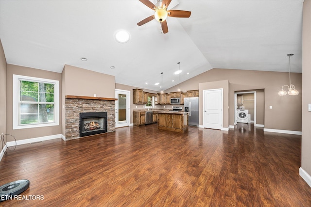 2689 Spruce Loop, Crossville, TN 38555 - living area featuring washer / clothes dryer, a ceiling fan, vaulted ceiling, a stone fireplace, and baseboards
