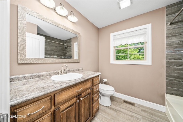 2689 Spruce Loop, Crossville, TN 38555 - bathroom featuring vanity, baseboards, toilet, and wood finished floors