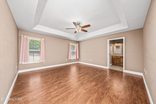 2689 Spruce Loop, Crossville, TN 38555 - empty room featuring a raised ceiling, ceiling fan, wood finished floors, and baseboards