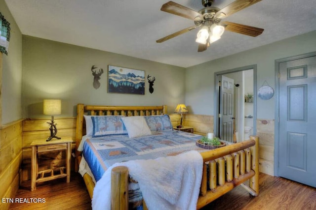 645 Wiley Oakley Dr, Gatlinburg, TN 37738 - bedroom featuring wood finished floors, ensuite bath, and a ceiling fan