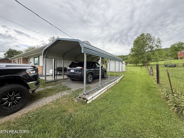 view of parking / parking lot featuring a detached carport and dirt driveway