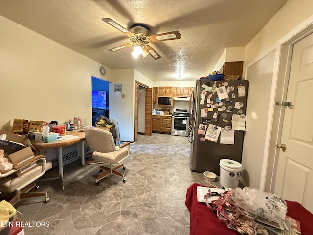 dining room featuring stone floors, a textured ceiling, and ceiling fan