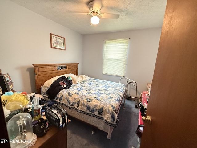 bedroom with a textured ceiling, ceiling fan, and wood finished floors