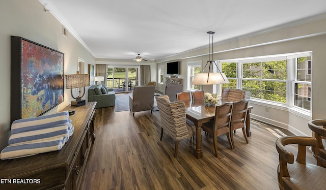 dining room with ornamental molding, dark wood-style flooring, baseboards, and a ceiling fan