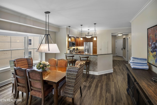 dining room featuring dark wood finished floors, crown molding, and baseboards