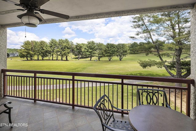 balcony featuring a ceiling fan and view of golf course