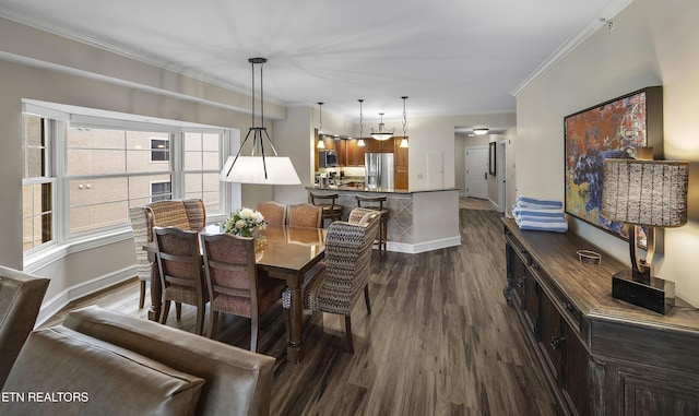 dining room with dark wood-style floors, ornamental molding, and baseboards
