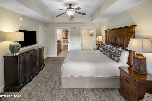 bedroom with carpet, baseboards, ensuite bath, and ceiling fan