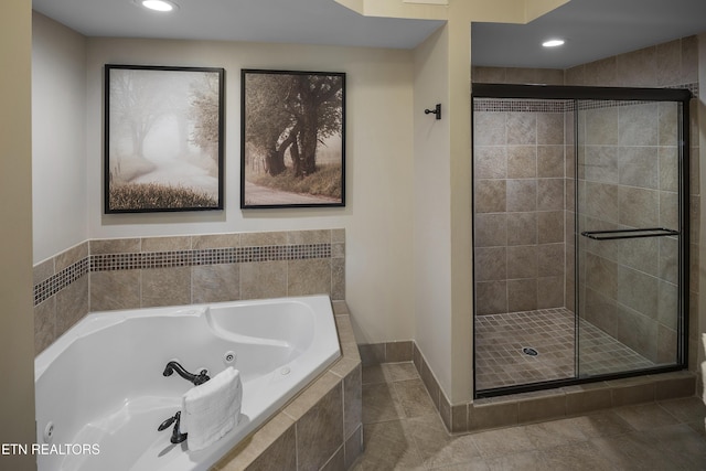 full bath featuring a shower stall, a jetted tub, baseboards, recessed lighting, and tile patterned floors