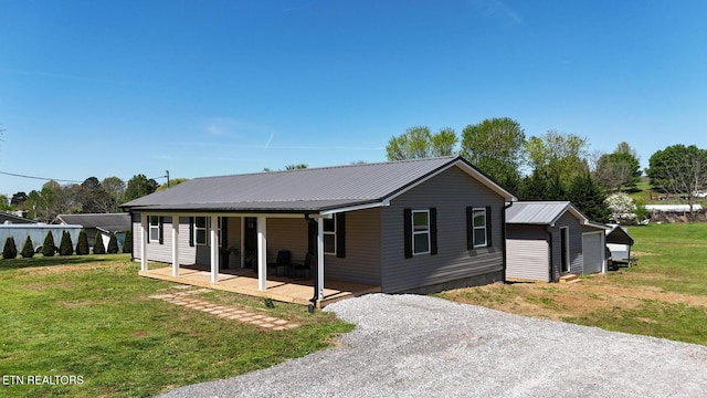 1712 Old Oak Grove Rd, Dandridge, TN 37725 - view of front of property with covered porch, a front yard, metal roof, and gravel driveway