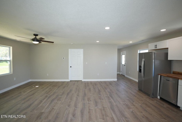 1712 Old Oak Grove Rd, Dandridge, TN 37725 - unfurnished living room with recessed lighting, baseboards, a ceiling fan, wood finished floors, and a textured ceiling