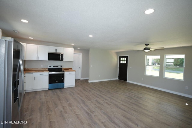 1712 Old Oak Grove Rd, Dandridge, TN 37725 - kitchen featuring appliances with stainless steel finishes, wood counters, open floor plan, white cabinets, and recessed lighting