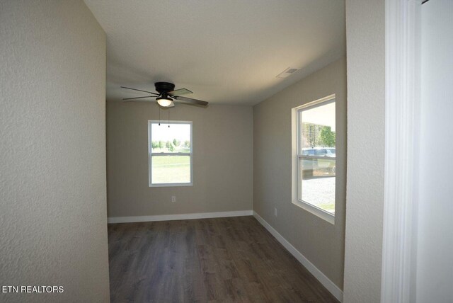 1712 Old Oak Grove Rd, Dandridge, TN 37725 - unfurnished room featuring dark wood-style floors, plenty of natural light, a ceiling fan, and baseboards