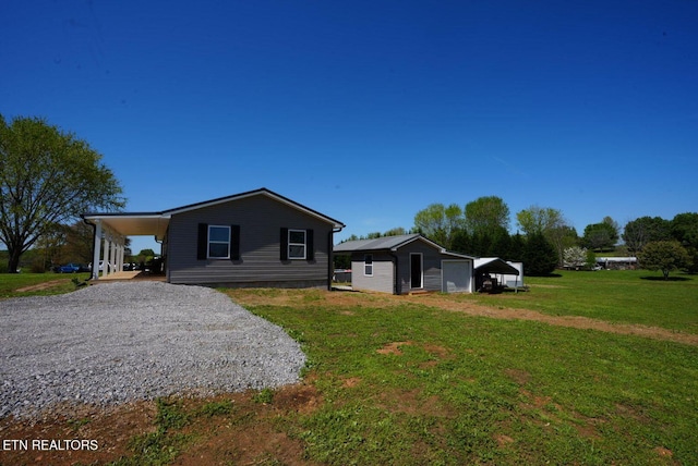 1712 Old Oak Grove Rd, Dandridge, TN 37725 - view of front of house featuring a front yard, an outbuilding, a garage, and driveway