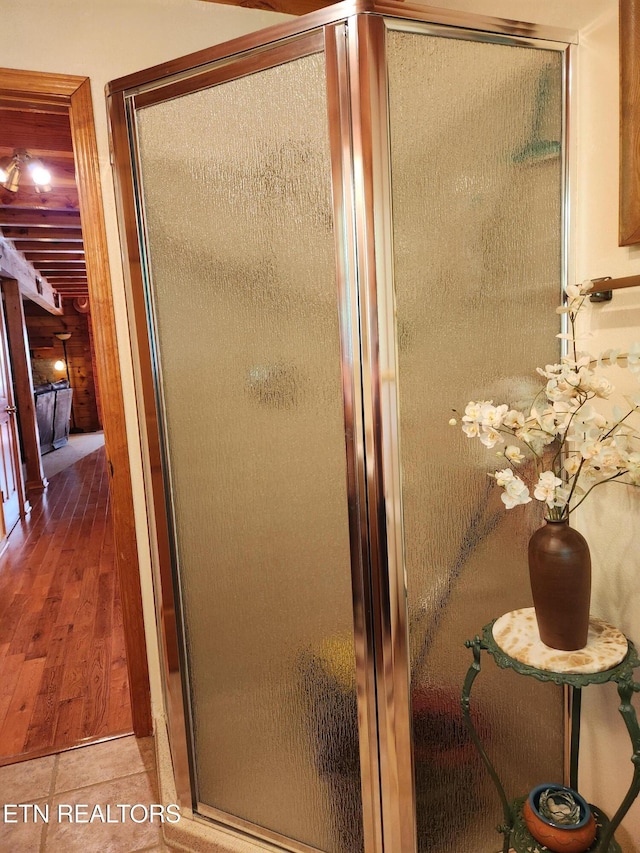 bathroom featuring a stall shower and wood finished floors