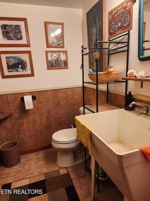 bathroom with toilet and wainscoting