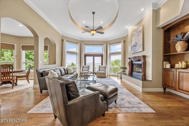 200 Bluffton Rd, Friendsville, TN 37737 - living area with crown molding, ceiling fan, a premium fireplace, wood finished floors, and baseboards