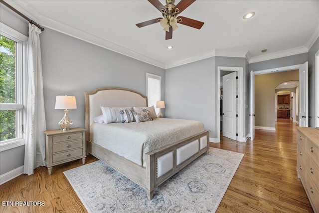 200 Bluffton Rd, Friendsville, TN 37737 - bedroom featuring arched walkways, baseboards, wood finished floors, crown molding, and recessed lighting