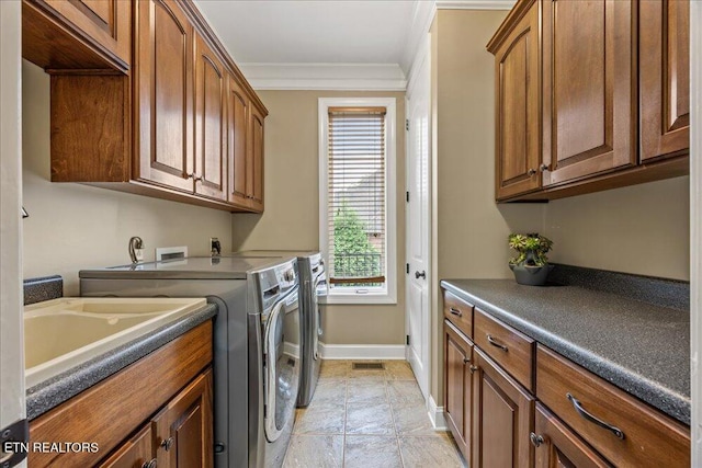 200 Bluffton Rd, Friendsville, TN 37737 - laundry room with washing machine and dryer, cabinet space, baseboards, and crown molding
