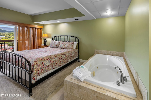 bedroom with carpet flooring and access to exterior