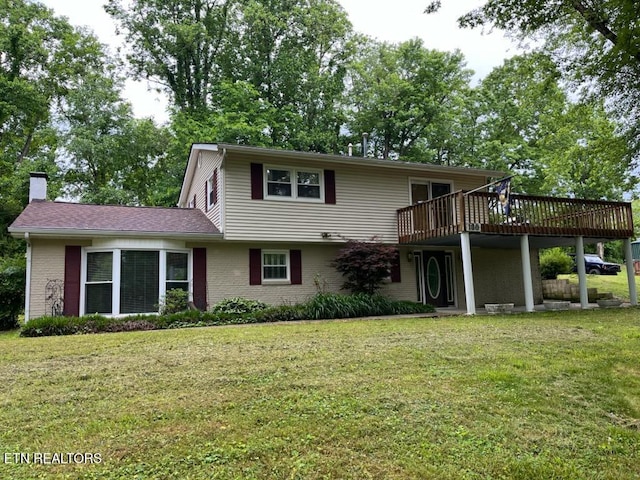 180 Cedar Ln, Jacksboro, TN 37757 - traditional-style home featuring a deck, a front yard, a chimney, and brick siding