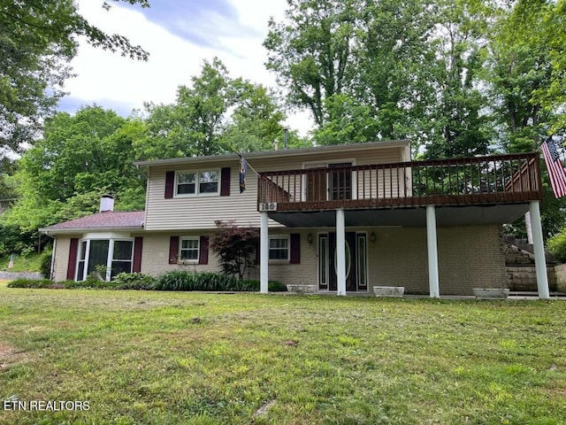 180 Cedar Ln, Jacksboro, TN 37757 - rear view of property featuring a deck, a yard, brick siding, and a chimney
