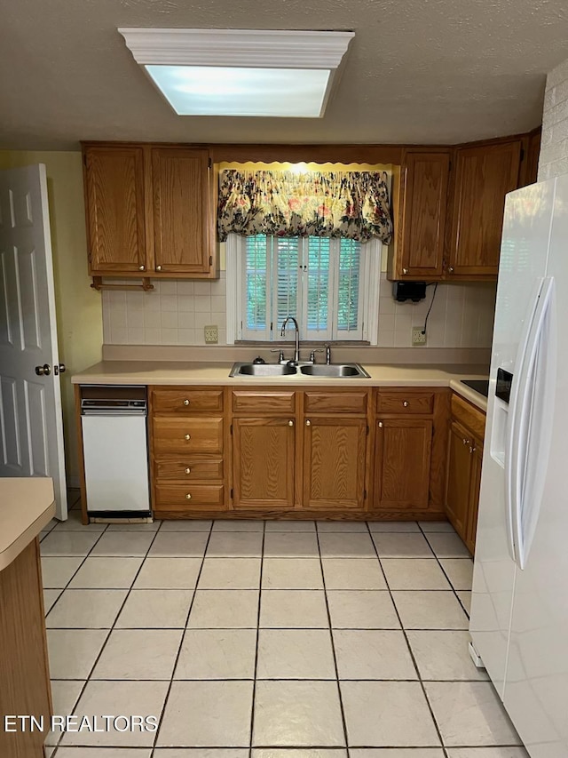 180 Cedar Ln, Jacksboro, TN 37757 - kitchen with white refrigerator with ice dispenser, a sink, brown cabinetry, and light countertops