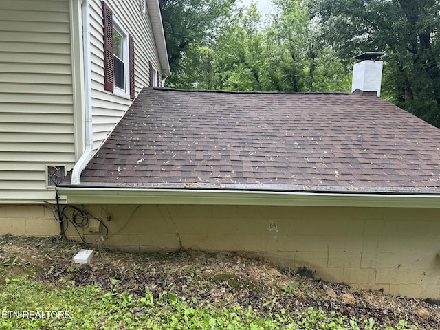 180 Cedar Ln, Jacksboro, TN 37757 - exterior view of a shingled roof, a chimney, a downspout, and gutters