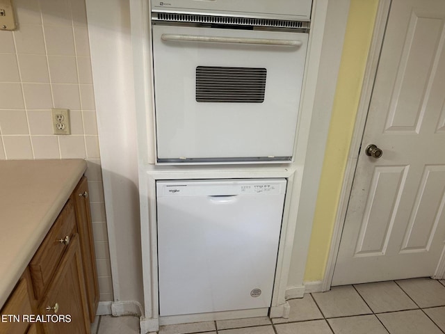 180 Cedar Ln, Jacksboro, TN 37757 - kitchen view of white appliances, tile walls, brown cabinets, and light countertops