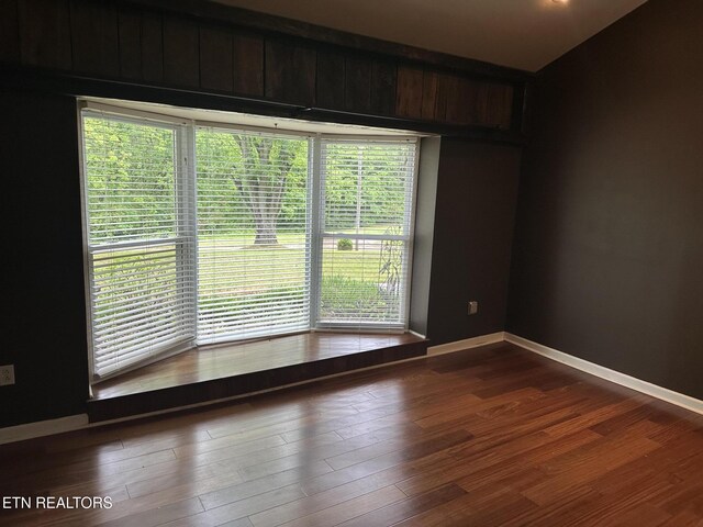 180 Cedar Ln, Jacksboro, TN 37757 - empty room with wood finished floors, baseboards, and plenty of natural light