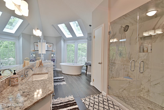 12212 Oakmont Cir, Knoxville, TN 37934 - bathroom with a skylight, a soaking tub, a stall shower, vanity, and wood tiled floors