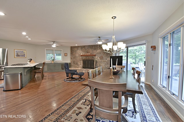 12212 Oakmont Cir, Knoxville, TN 37934 - dining room with ceiling fan, a fireplace, wood finished floors, healthy amount of natural light, and recessed lighting
