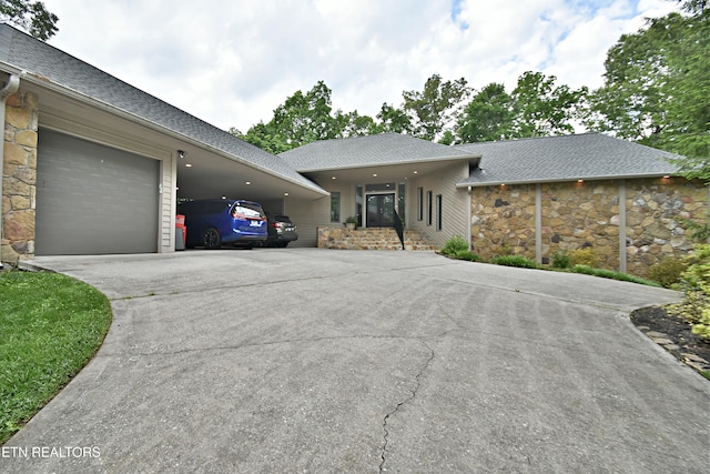 12212 Oakmont Cir, Knoxville, TN 37934 - view of front facade featuring concrete driveway, stone siding, roof with shingles, and a garage