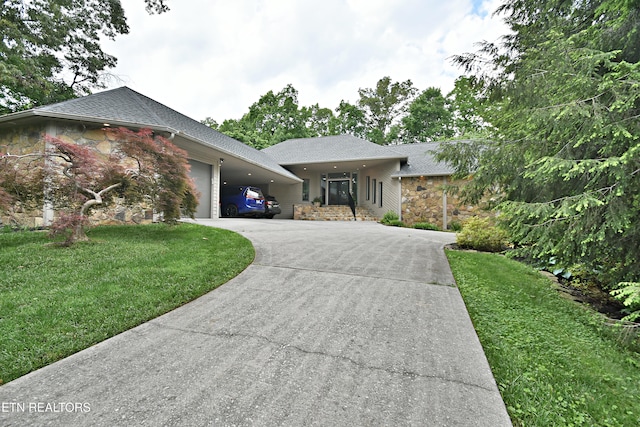 12212 Oakmont Cir, Knoxville, TN 37934 - view of front facade with stone siding, an attached garage, driveway, a shingled roof, and a front yard