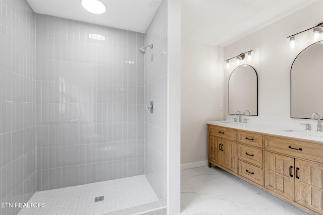 9505 Pearson Rd, Harrison, TN 37341 - bathroom with marble look tiles, a tile shower, double vanity, and baseboards