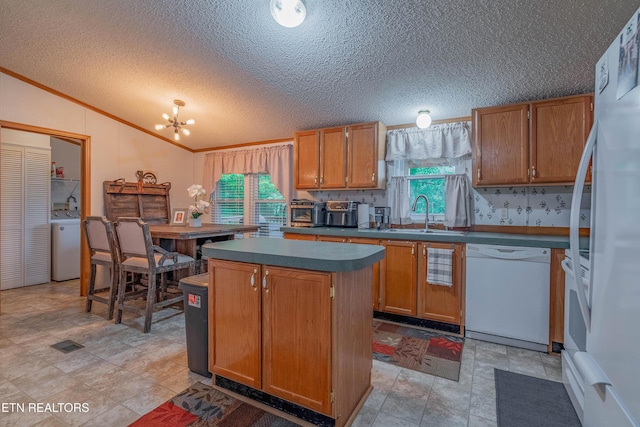 384 Lancer Rd, Harriman, TN 37748 - kitchen with white appliances, a sink, washer / clothes dryer, vaulted ceiling, and dark countertops