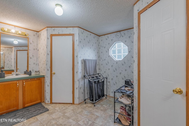 384 Lancer Rd, Harriman, TN 37748 - bathroom with ornamental molding, a textured ceiling, wallpapered walls, and vanity