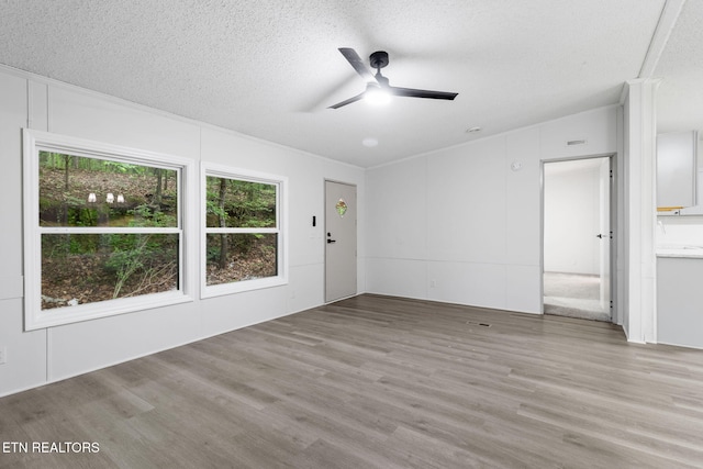 4817 Howardsville Rd, Apison, TN 37302 - unfurnished living room with wood finished floors, a textured ceiling, and ceiling fan