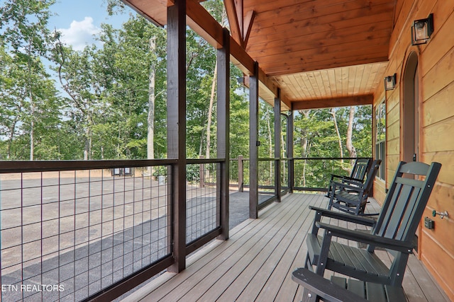 wooden terrace with view of scattered trees