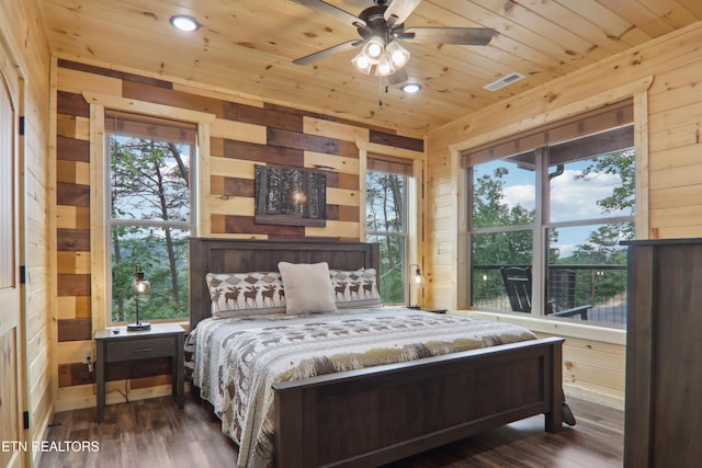 bedroom featuring wooden walls, wooden ceiling, wood finished floors, and recessed lighting