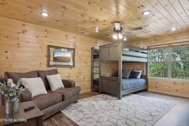 bedroom featuring wooden ceiling, wood finished floors, wood walls, and recessed lighting