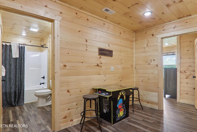 dining room with wooden ceiling, dark wood-style flooring, wooden walls, and recessed lighting