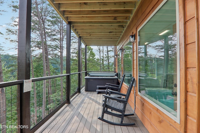 wooden terrace with a hot tub