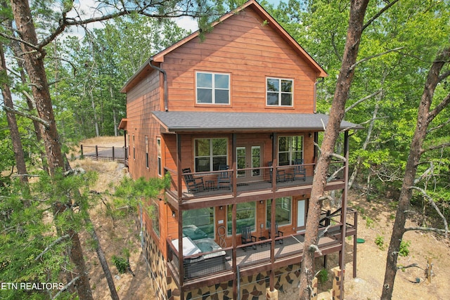 back of house with french doors, a wooden deck, roof with shingles, and fence