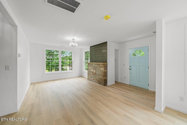 739 W Main St, Sevierville, TN 37862 - unfurnished living room with healthy amount of natural light, a chandelier, light wood finished floors, and baseboards